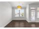 Dining area featuring a modern chandelier, a large window for natural light, and access to outdoor space at 8620 Secreto Dr, Raleigh, NC 27606