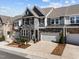 Stylish townhome featuring a stone and siding exterior, with a two-car garage and inviting driveway at 8620 Secreto Dr, Raleigh, NC 27606