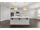 Bright, modern kitchen with a center island, white cabinets, stainless steel appliances, and stylish pendant lighting at 8620 Secreto Dr, Raleigh, NC 27606
