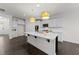 Modern kitchen features an island with seating, stainless steel appliances, and plenty of cabinet space at 8620 Secreto Dr, Raleigh, NC 27606