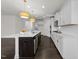 Well-lit kitchen with an island, stainless steel appliances, and white cabinetry, offering ample counter space at 8620 Secreto Dr, Raleigh, NC 27606