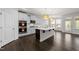 Open kitchen featuring stainless steel appliances, white cabinets, a subway tile backsplash, and a large island at 8620 Secreto Dr, Raleigh, NC 27606