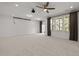 Large living room with neutral carpet, recessed lighting, projector, and ample windows at 8620 Secreto Dr, Raleigh, NC 27606