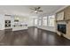 Open-concept living area with a kitchen, fireplace, and access to an outdoor space via glass doors at 8620 Secreto Dr, Raleigh, NC 27606