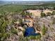 Secluded property featuring a beautiful pond and a well-maintained home surrounded by lush trees at 902 Zion Church Rd, Sanford, NC 27330