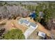 Expansive aerial shot of the property featuring a home, pond, and wooded area at 902 Zion Church Rd, Sanford, NC 27330