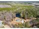 Sprawling landscape showcasing a home nestled in a wooded area with a private pond at 902 Zion Church Rd, Sanford, NC 27330