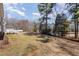 Lush backyard with mature trees and a view of the deck, providing privacy and natural beauty at 902 Zion Church Rd, Sanford, NC 27330