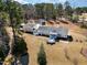 Aerial view showcases a home with deck, patio, and expansive wooded backyard at 902 Zion Church Rd, Sanford, NC 27330