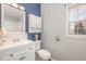 Bright bathroom featuring a vanity with storage and a tiled shower-tub at 902 Zion Church Rd, Sanford, NC 27330