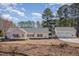 Charming home featuring a welcoming front porch and an attached three-car garage at 902 Zion Church Rd, Sanford, NC 27330