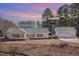 Inviting home with a classic design set against a vibrant sunset backdrop at 902 Zion Church Rd, Sanford, NC 27330