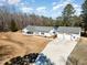Aerial view of a charming white home with a long driveway and attached three-car garage at 902 Zion Church Rd, Sanford, NC 27330