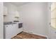 Bright laundry area featuring modern washer and dryer units, wooden-look floor and ample storage at 902 Zion Church Rd, Sanford, NC 27330