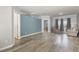 Open-concept living room with hardwood floors and large windows, seamlessly connecting spaces at 902 Zion Church Rd, Sanford, NC 27330