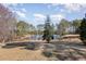 Picturesque view of the tranquil pond reflecting the surrounding trees and sky at 902 Zion Church Rd, Sanford, NC 27330