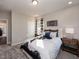 Comfortable bedroom featuring stylish decor, soft gray carpet, and natural light at 909 Thimbleweed Way, Wake Forest, NC 27587