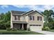 Charming two-story home features a classic design, well-manicured lawn, and inviting curb appeal at 909 Thimbleweed Way, Wake Forest, NC 27587