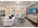 Bright living room with hardwood floors, stylish furniture, and large windows offering natural light at 909 Thimbleweed Way, Wake Forest, NC 27587