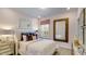 Charming bedroom with soft pink walls, a comfortable bed, and unique decorative mirror at 913 Thimbleweed Way, Wake Forest, NC 27587