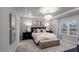 Serene bedroom with a tray ceiling, chandelier, and plush bedding offering a relaxing retreat at 913 Thimbleweed Way, Wake Forest, NC 27587