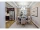 Elegant dining room with stylish chandelier, neutral decor, and view into the modern kitchen at 913 Thimbleweed Way, Wake Forest, NC 27587