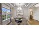Elegant dining room with a round table, stylish chandelier, and large window, perfect for entertaining guests at 913 Thimbleweed Way, Wake Forest, NC 27587