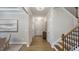 Elegant foyer featuring hardwood floors, stairway, and stylish lighting, creating a welcoming entrance at 913 Thimbleweed Way, Wake Forest, NC 27587