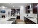 Spacious kitchen featuring dark cabinets, stainless appliances, an island with a sink, and a gas cooktop at 913 Thimbleweed Way, Wake Forest, NC 27587