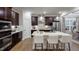Modern kitchen with dark cabinets, white countertops, stainless steel appliances, and stylish pendant lighting at 913 Thimbleweed Way, Wake Forest, NC 27587