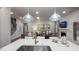Modern kitchen with island sink, stainless steel appliances, and view of living room with fireplace at 913 Thimbleweed Way, Wake Forest, NC 27587