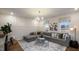 Comfortable living room with a large sectional sofa, stylish decor, and plenty of natural light at 913 Thimbleweed Way, Wake Forest, NC 27587