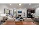 Cozy living room featuring a fireplace, plush sofas, built-in cabinets, and a convenient kitchen bar at 913 Thimbleweed Way, Wake Forest, NC 27587