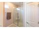 Bathroom featuring a glass shower, towel rack, and a white door with a silver handle at 100 Pinto Saddle Ct, Garner, NC 27529
