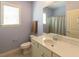 Bathroom featuring a marble vanity, toilet, and window, offering a serene space at 100 Pinto Saddle Ct, Garner, NC 27529