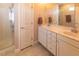 Bright bathroom with a double vanity, a glass enclosed shower and tile flooring at 100 Pinto Saddle Ct, Garner, NC 27529