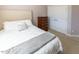Bedroom with a cozy white comforter, dresser, and closet, creating a welcoming space at 100 Pinto Saddle Ct, Garner, NC 27529