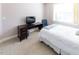 Bedroom with a white comforter bed, desk, and chair, enhanced by natural light from the window at 100 Pinto Saddle Ct, Garner, NC 27529
