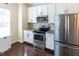 This kitchen has white cabinets, stainless steel appliances and hard wood floors at 100 Pinto Saddle Ct, Garner, NC 27529