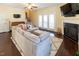 Cozy living room with fireplace, tv, gray sectional and stairway at 100 Pinto Saddle Ct, Garner, NC 27529