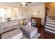 Spacious living room featuring wood floors, a gray sectional and a desk at 100 Pinto Saddle Ct, Garner, NC 27529