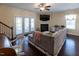Cozy living room features hardwood floors, fireplace, and French doors to the exterior at 100 Pinto Saddle Ct, Garner, NC 27529