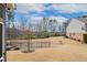 Large backyard with grass, black metal fence, and line of mature trees at 1015 Rexburg Dr, Cary, NC 27513