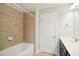 Bathroom featuring a white bathtub and shower combination with tiled walls at 1015 Rexburg Dr, Cary, NC 27513