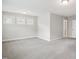 Bright bedroom with neutral carpet, multiple windows, and view of open doorway on right at 1015 Rexburg Dr, Cary, NC 27513