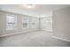 Spacious bedroom with neutral carpet, multiple windows offering natural light, and base trim throughout at 1015 Rexburg Dr, Cary, NC 27513