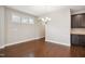 Open dining area featuring hardwood floors, natural light, and dark wood cabinetry at 1015 Rexburg Dr, Cary, NC 27513