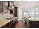 Modern kitchen featuring stainless steel appliances, granite countertops, and dark wood cabinetry at 1015 Rexburg Dr, Cary, NC 27513
