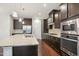 Modern kitchen featuring granite countertops, stainless steel appliances, and a large island at 1015 Rexburg Dr, Cary, NC 27513