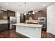 Modern kitchen with stainless steel appliances, a central island, and dark wood cabinets at 1015 Rexburg Dr, Cary, NC 27513